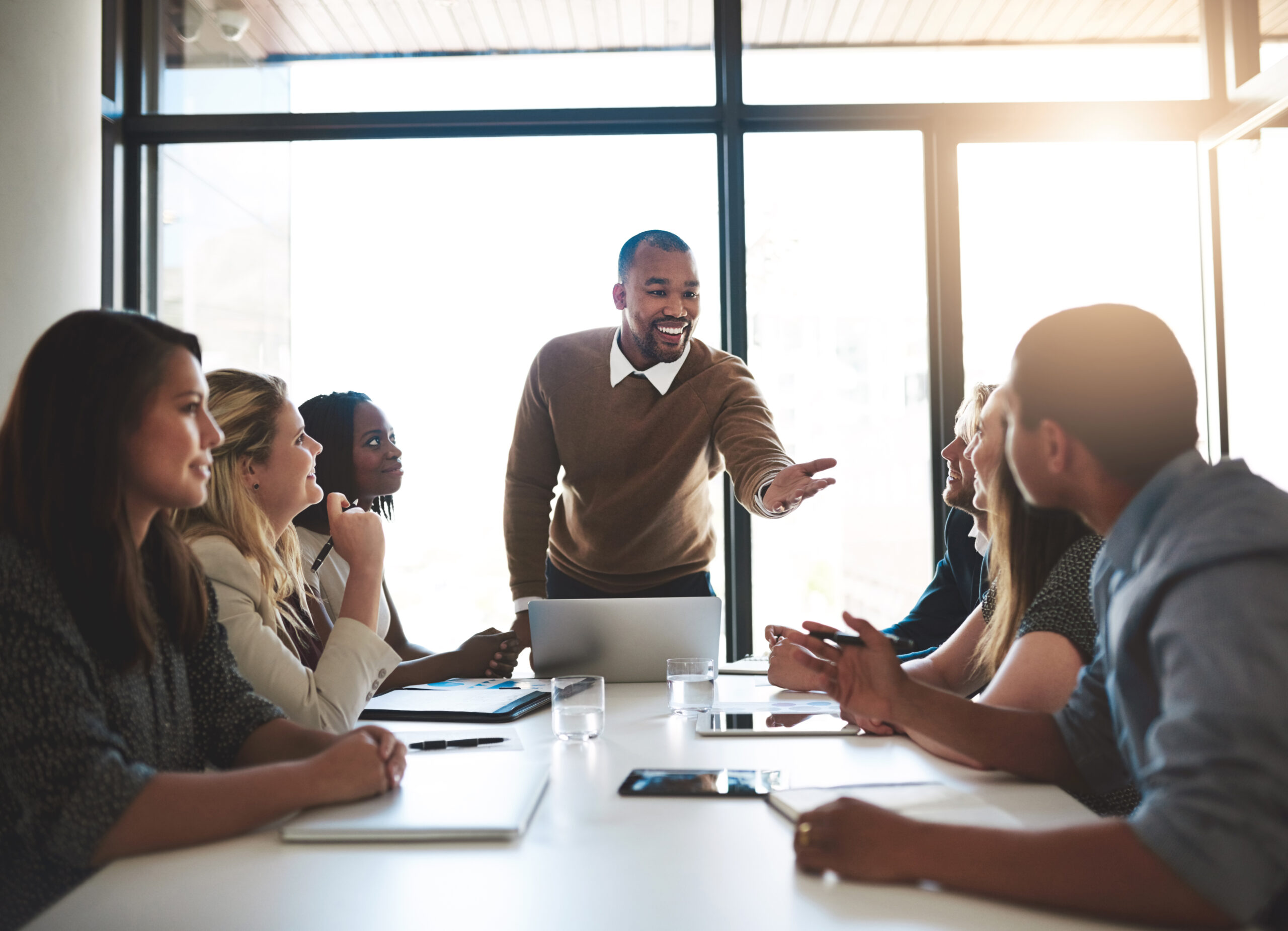 Shot of a young businessman leading his team in a meeting in the office.