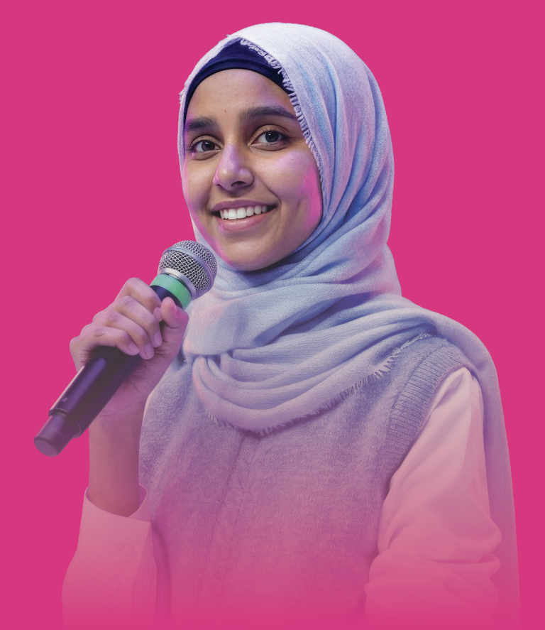 Student smiling while holding a microphone