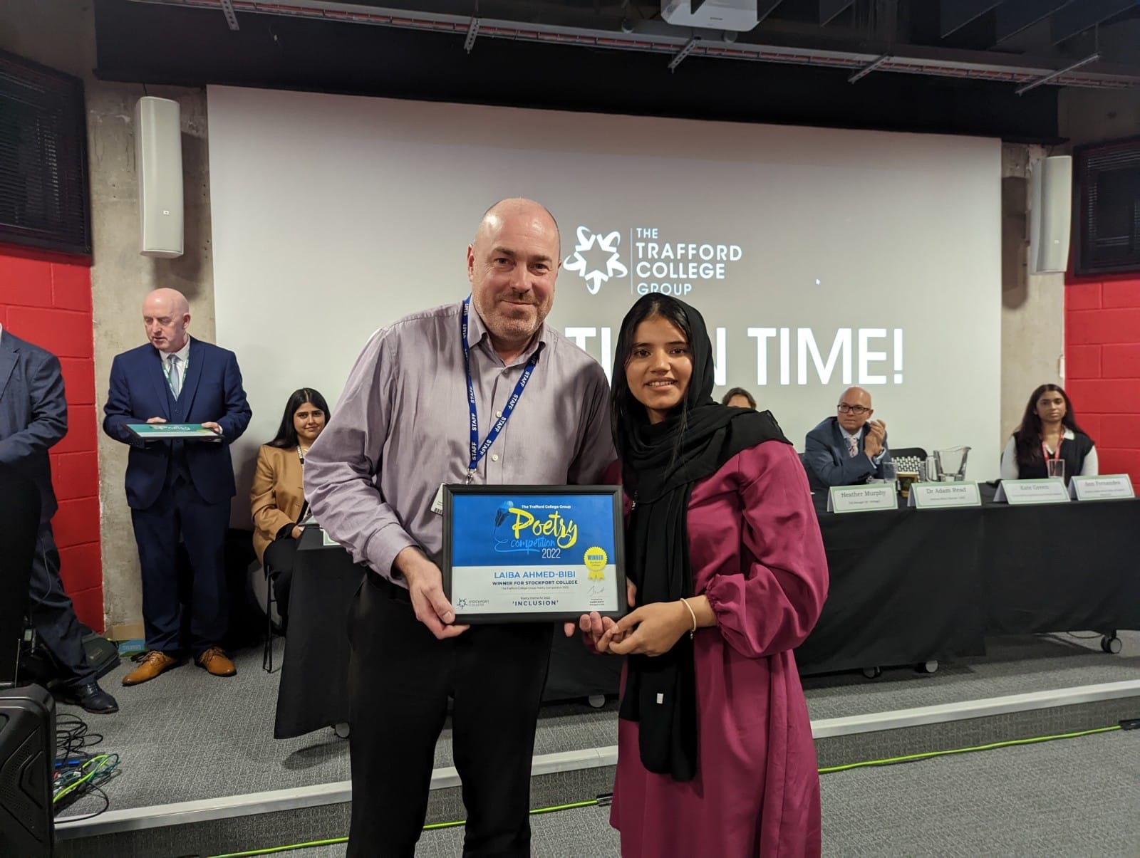 Annual poetry competition winner collecting the plaque.