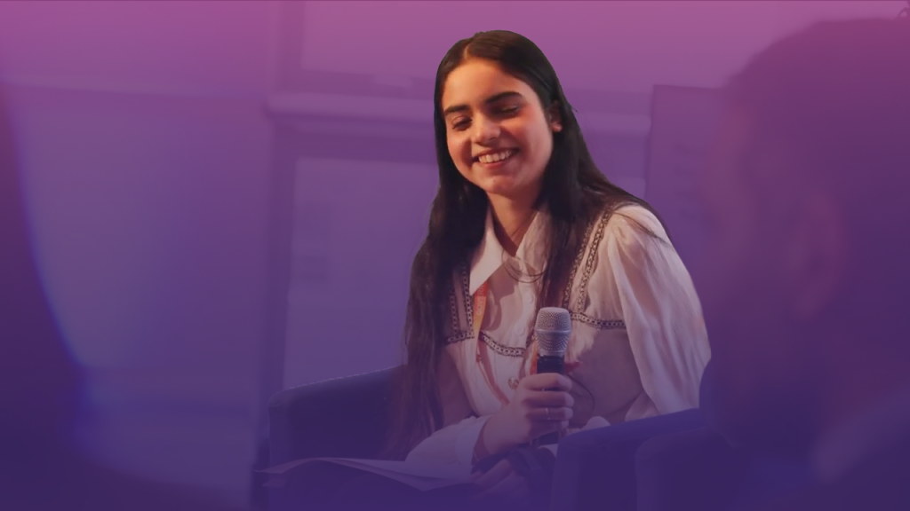 student smiling with microphone